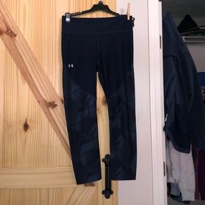 Navy blue girls Under Armor leggings with triangular pattern.